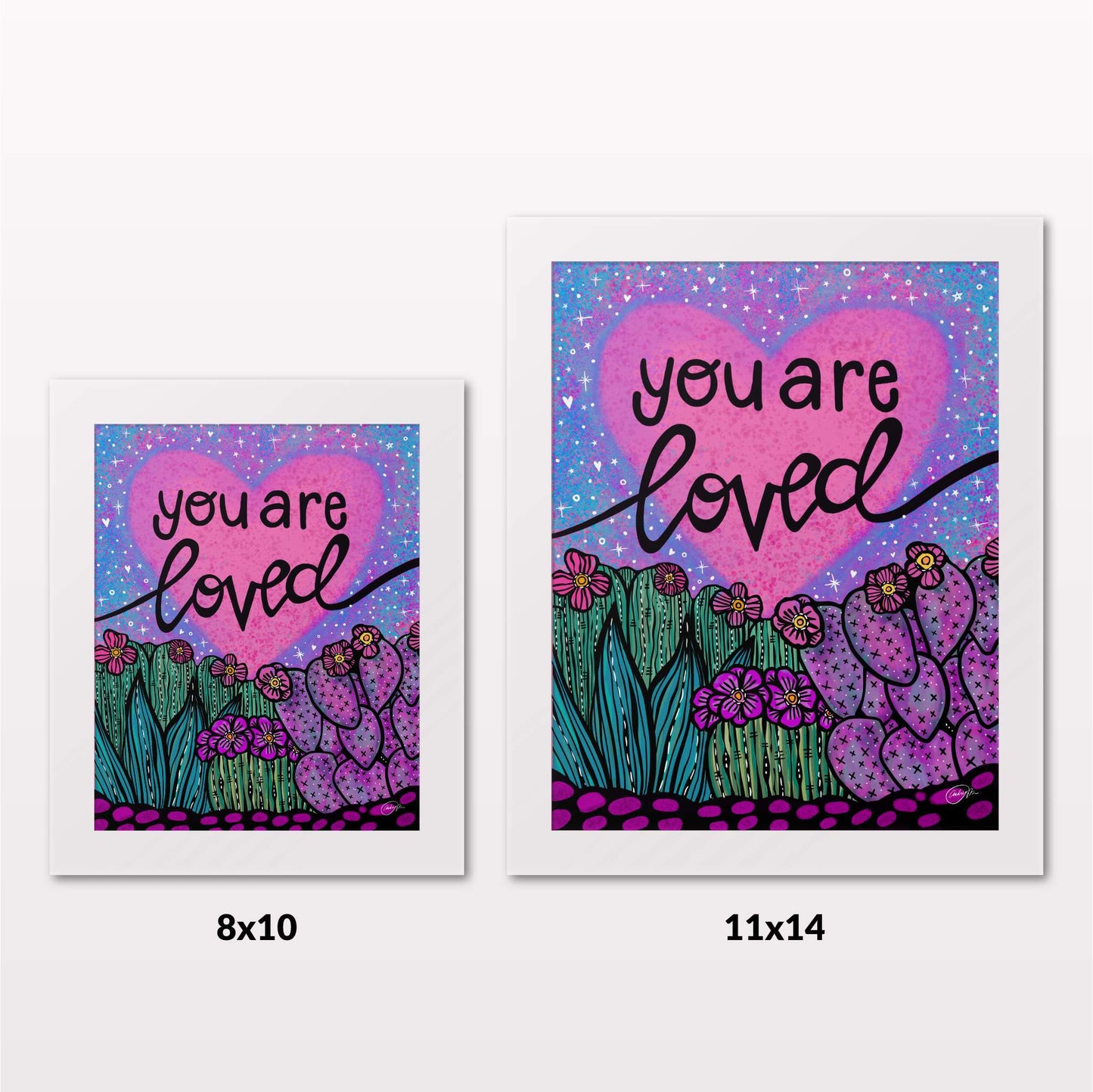 Comparing 8x10 and 11x14 framed art prints on a white wall